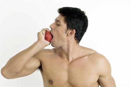 red apple bite - Fit young man biting an apple Stock Photo - Premium Royalty-Free, Code: 644-02923403