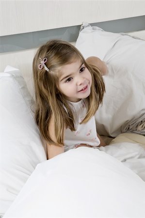 portuguese - Girl sitting on bed Stock Photo - Premium Royalty-Free, Code: 644-02923484