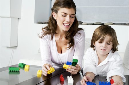 Young woman and boy playing with building blocks Stock Photo - Premium Royalty-Free, Code: 644-02923602