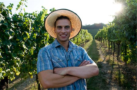 Young man in casual dress in front of vineyard Stock Photo - Premium Royalty-Free, Code: 644-03405433