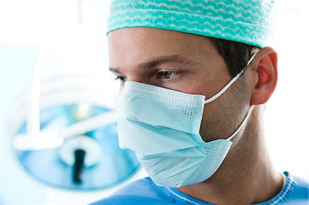 sterilized surgical nurse - Close up of surgeon in operating room Stock Photo - Premium Royalty-Free, Code: 644-03659453