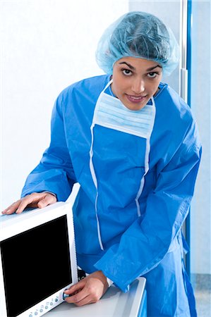 simsearch:644-03672142,k - Surgeon adjusting monitor in operating room Stock Photo - Premium Royalty-Free, Code: 644-03659483