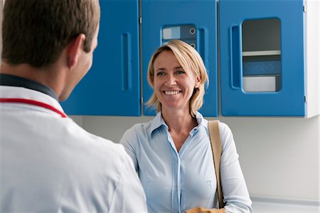 female doctor with male patient - Happy patient visiting doctor Stock Photo - Premium Royalty-Free, Code: 644-03659515