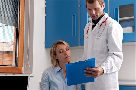 female doctor with male patient - Doctor and patient discussing medical chart Stock Photo - Premium Royalty-Free, Code: 644-03659521