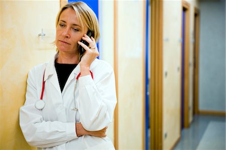 departmental - Doctor making telephone call in medical center Stock Photo - Premium Royalty-Free, Code: 644-03659572