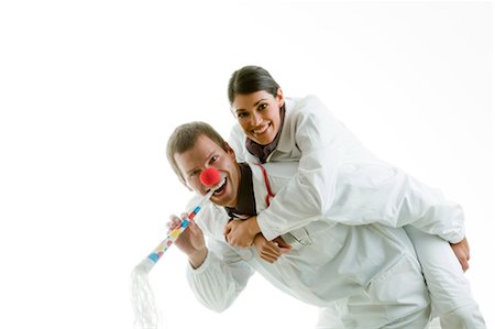 Male and female doctors playing with party toys Stock Photo - Premium Royalty-Free, Code: 644-03659591