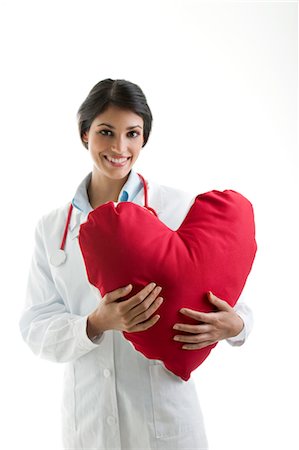 Doctor holding heart pillow Stock Photo - Premium Royalty-Free, Code: 644-03659607