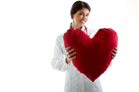 Doctor holding heart pillow Foto de stock - Sin royalties Premium, Código: 644-03659608