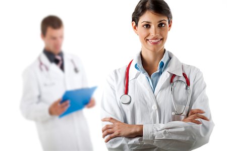 Doctor with arms folded and doctor reading medical chart Stock Photo - Premium Royalty-Free, Code: 644-03659628