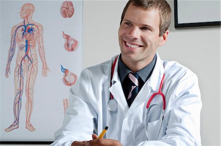 Médecin dans son bureau avec système circulatoire tableau sur le mur Photographie de stock - Premium Libres de Droits, Code: 644-03659658