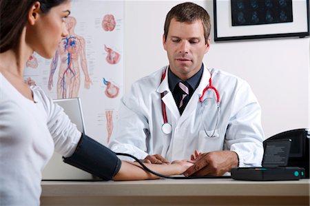 Doctor taking patient's blood pressure Stock Photo - Premium Royalty-Free, Code: 644-03659667