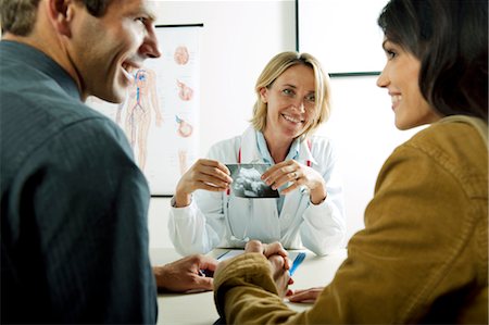 female doctor with male patient - Doctor with ultrasound and couple Stock Photo - Premium Royalty-Free, Code: 644-03659687