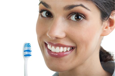 Young woman holding toothbrush Stock Photo - Premium Royalty-Free, Code: 644-03672137