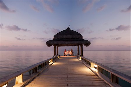 fine dining people not eye contact - Couple eating on tropical dock Stock Photo - Premium Royalty-Free, Code: 649-04247573