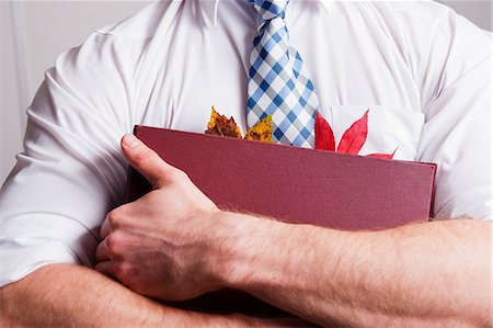 red shirt - Leaves in businessman's folder Stock Photo - Premium Royalty-Free, Code: 649-04247725