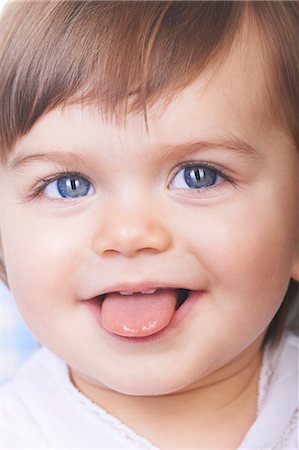 Baby girl sticking out her tongue Stock Photo - Premium Royalty-Free, Code: 649-04247883