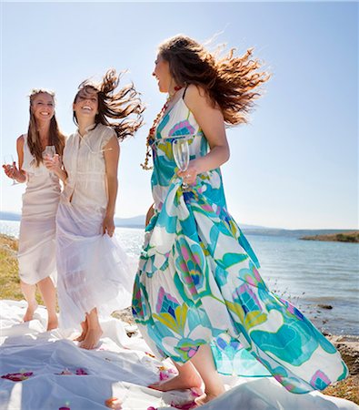 friends jumping outdoors - Bride drinking champagne with friends Stock Photo - Premium Royalty-Free, Code: 649-04248535