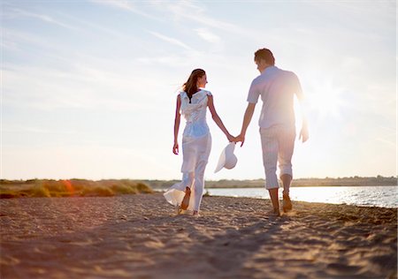 people holding hands on beach - Newlywed couple walking on beach Stock Photo - Premium Royalty-Free, Code: 649-04248579