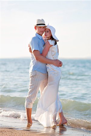 elegant couple embracing - Newlywed couple embracing on beach Stock Photo - Premium Royalty-Free, Code: 649-04248571