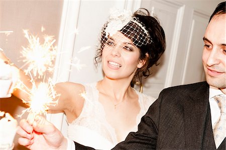 Newlywed couple with sparklers on cake Stock Photo - Premium Royalty-Free, Code: 649-04248679