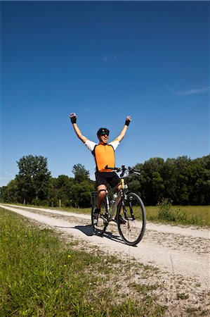 senior cyclist - Biker cheering on dirt road Stock Photo - Premium Royalty-Free, Code: 649-04248690