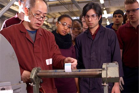 students learn group - Worker using rollers in factory Stock Photo - Premium Royalty-Free, Code: 649-04248884