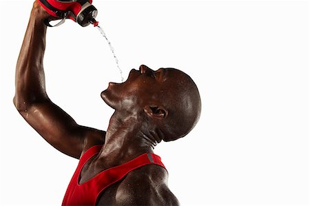 plastic bottles water - Athlete pouring water into his mouth Stock Photo - Premium Royalty-Free, Code: 649-04827178