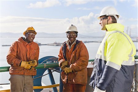 dock worker pictures - Workers talking on oil rig Stock Photo - Premium Royalty-Free, Code: 649-04827648