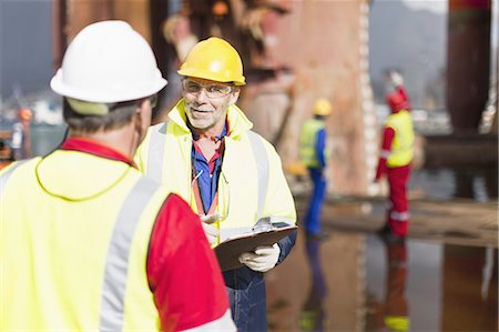 Workers talking on oil rig Stock Photo - Premium Royalty-Free, Code: 649-04827676