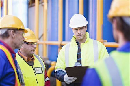 Workers talking on oil rig Stock Photo - Premium Royalty-Free, Code: 649-04827694