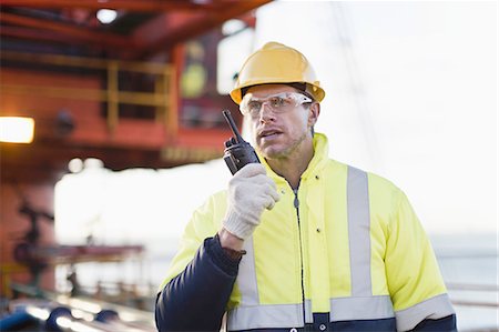 simsearch:6110-07233641,k - Worker using walkie talkie on oil rig Stock Photo - Premium Royalty-Free, Code: 649-04827715