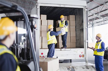 delivery man delivering boxes - Workers unloading boxes from truck Stock Photo - Premium Royalty-Free, Code: 649-04827763