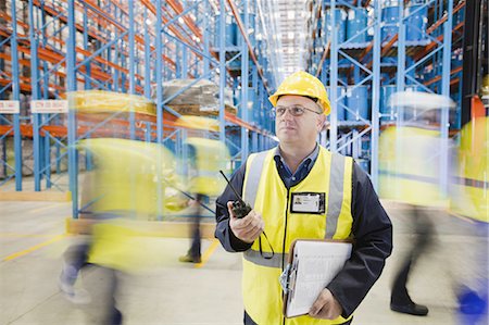 Time lapse view of workers in warehouse Stock Photo - Premium Royalty-Free, Code: 649-04827783