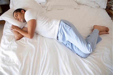 sleeping bed full body - Man asleep on bed Stock Photo - Premium Royalty-Free, Code: 649-04828686