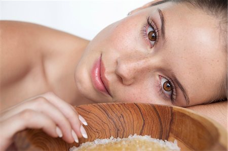 Woman laying by bowl of sugar Stock Photo - Premium Royalty-Free, Code: 649-05520803