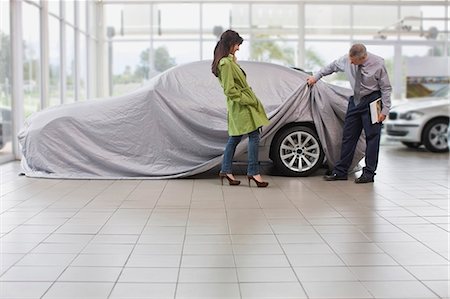 sheet - Car salesman displaying car for woman Stock Photo - Premium Royalty-Free, Code: 649-05521289