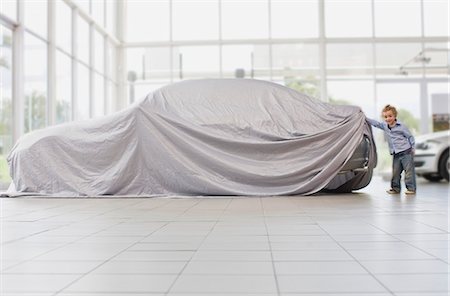 Girl peeking under cloth on car Stock Photo - Premium Royalty-Free, Code: 649-05521282