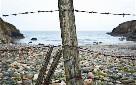 forbidding - Barbed wire fence on rocky beach Stock Photo - Premium Royalty-Free, Code: 649-05521531