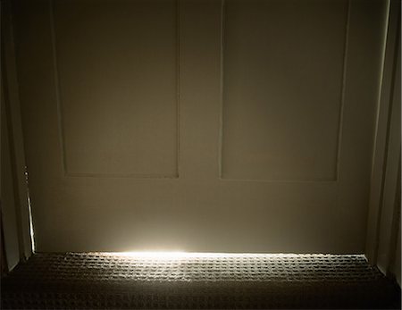 Light glowing from under door Stock Photo - Premium Royalty-Free, Code: 649-05521533