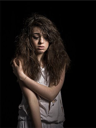 standing teen scared - Crying girl with messy hair Stock Photo - Premium Royalty-Free, Code: 649-05521916