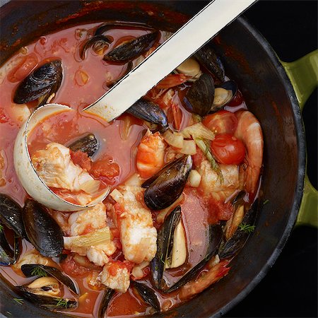 pots on a stove - Ladle in pot of fish stew Stock Photo - Premium Royalty-Free, Code: 649-05522654