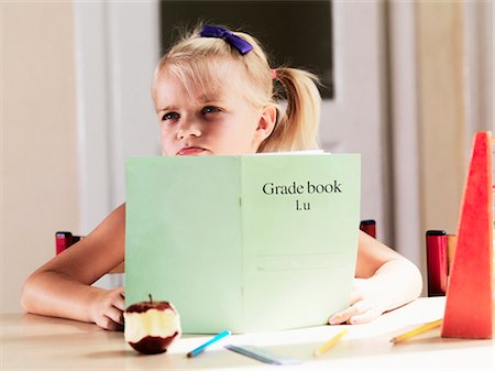 red pigtails - Bored girl doing homework at desk Stock Photo - Premium Royalty-Free, Code: 649-05556136