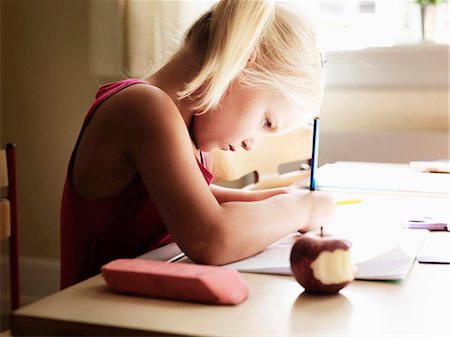 student thinking in a classroom - Girl doing homework at desk Stock Photo - Premium Royalty-Free, Code: 649-05556133