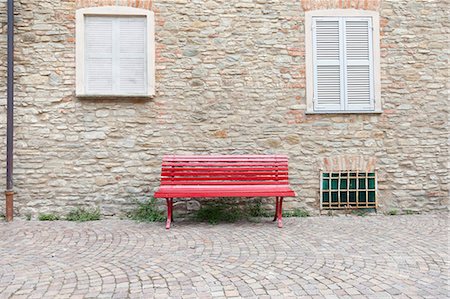 european bench - Red bench on cobbled village street Stock Photo - Premium Royalty-Free, Code: 649-05556596