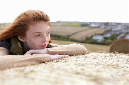 red hair girl teen alone - Teenage girl resting on haybale Stock Photo - Premium Royalty-Free, Code: 649-05649171