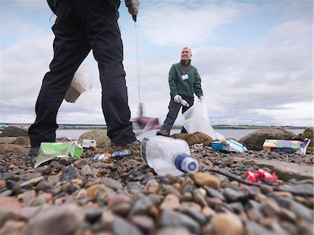 Environmentalist cleaning up beach Stock Photo - Premium Royalty-Free, Code: 649-05649428