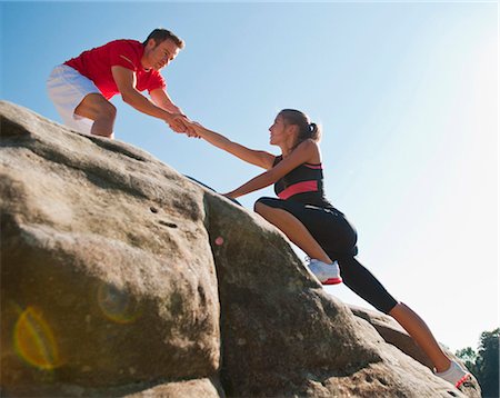 Rock climbers helping each other Fotografie stock - Premium Royalty-Free, Codice: 649-05649703