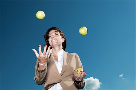 people juggling - Businesswoman juggling apples outdoors Stock Photo - Premium Royalty-Free, Code: 649-05656567