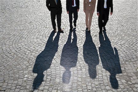 people line overhead - Shadows walking on cobbled road Stock Photo - Premium Royalty-Free, Code: 649-05656579