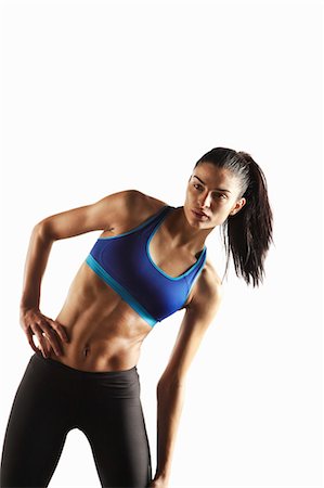 stretching (people exercising) - Athlete stretching with hand on hip Stock Photo - Premium Royalty-Free, Code: 649-05656725